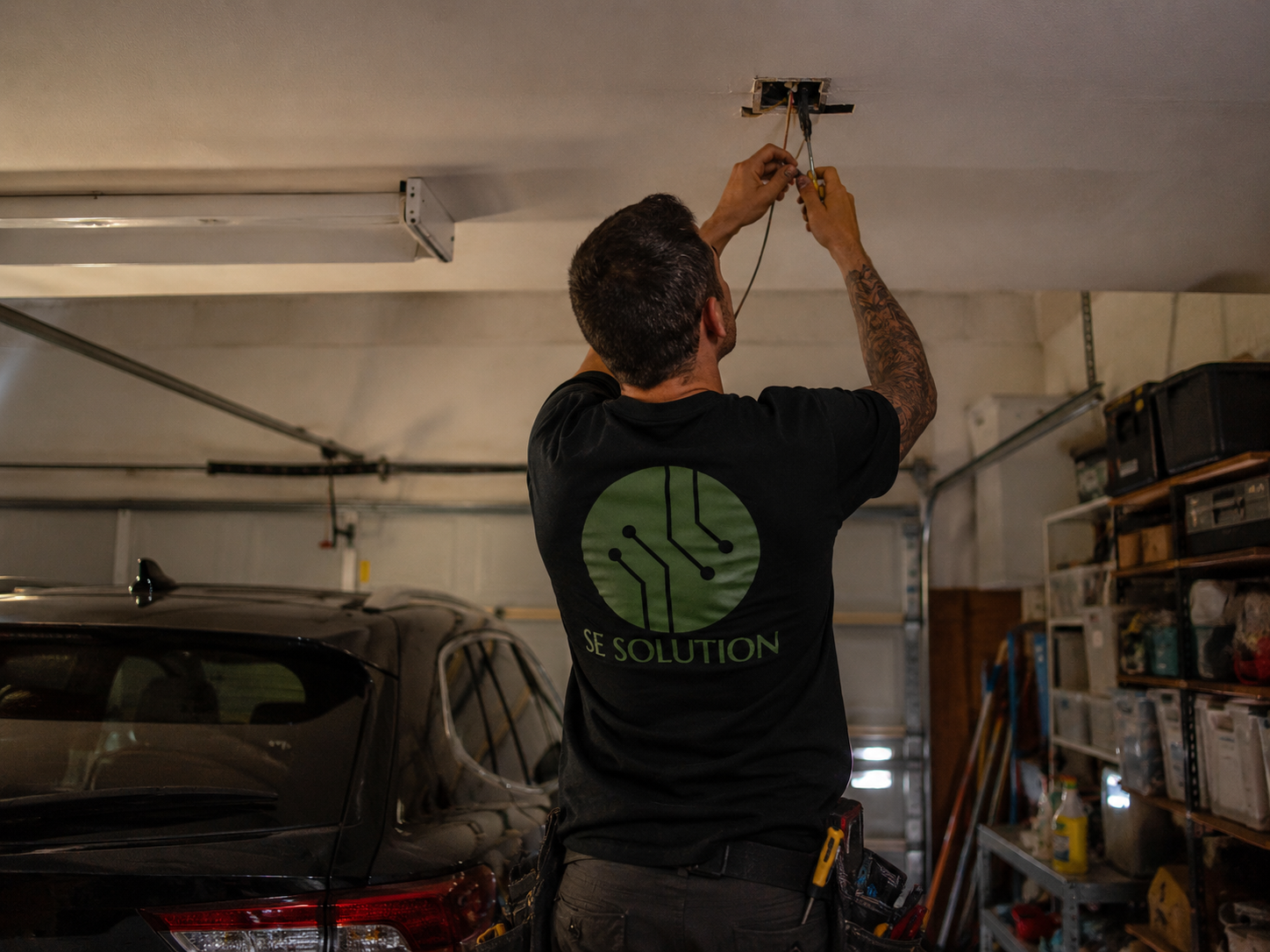 Electrician upgrading garage ceiling lighting, Metro Detroit, MI